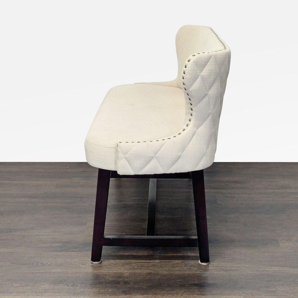 Upholstered bench from Stools, Ottomans & Benches, with button quilting and nailhead-trimmed sides.
