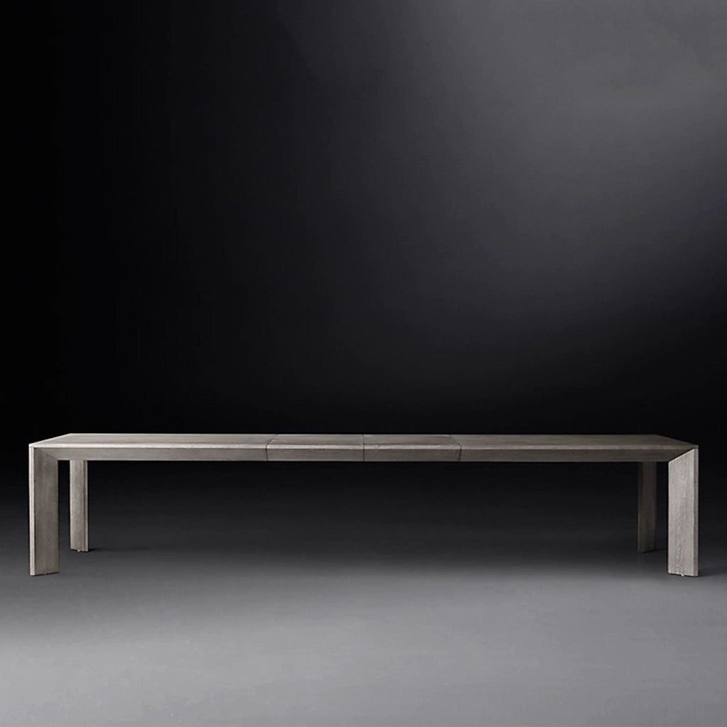 Modern Parsons-style dining table featuring dramatic angled legs and a spacious extendable surface.