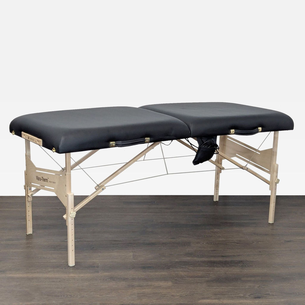 Sturdy wooden Earthlite table with cushioned black top for massage therapy, designed for easy setup and folding.
