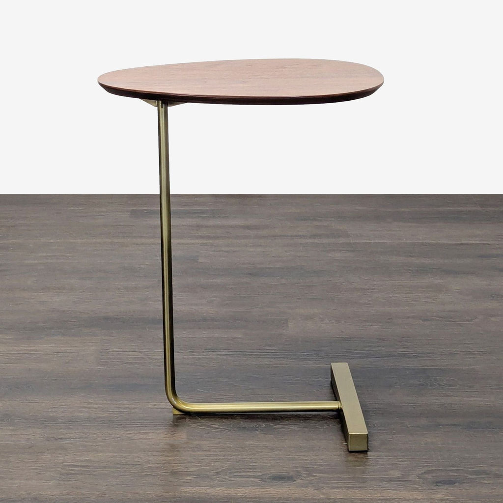 3. Contemporary West Elm side table with walnut top and L-shaped antiqued brass base, indoor setting.