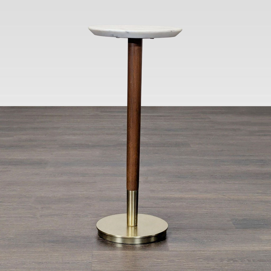 Round side table with a marble top, mango wood stem, and metal base by West Elm.  