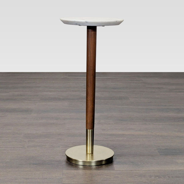 Round side table with a marble top, mango wood stem, and metal base by West Elm.  