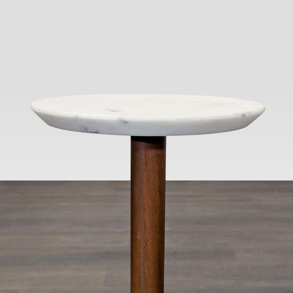 West Elm side table featuring a marble surface, wooden stem, and a sturdy metal base.  