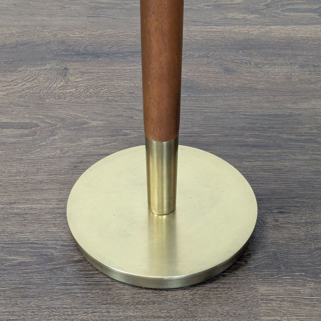 Modern console table with a white marble top, mango wood pillar, and round metal base.