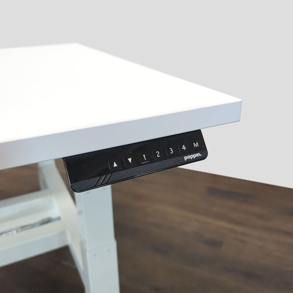 Poppin sit-stand desk with two separate white surfaces, ergonomic electric lifts, and easy-to-use controls for offices.