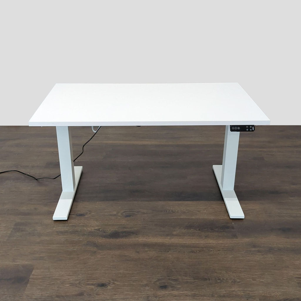 White electric height-adjustable Poppin desk with simple controls for smooth sitting or standing transitions.  