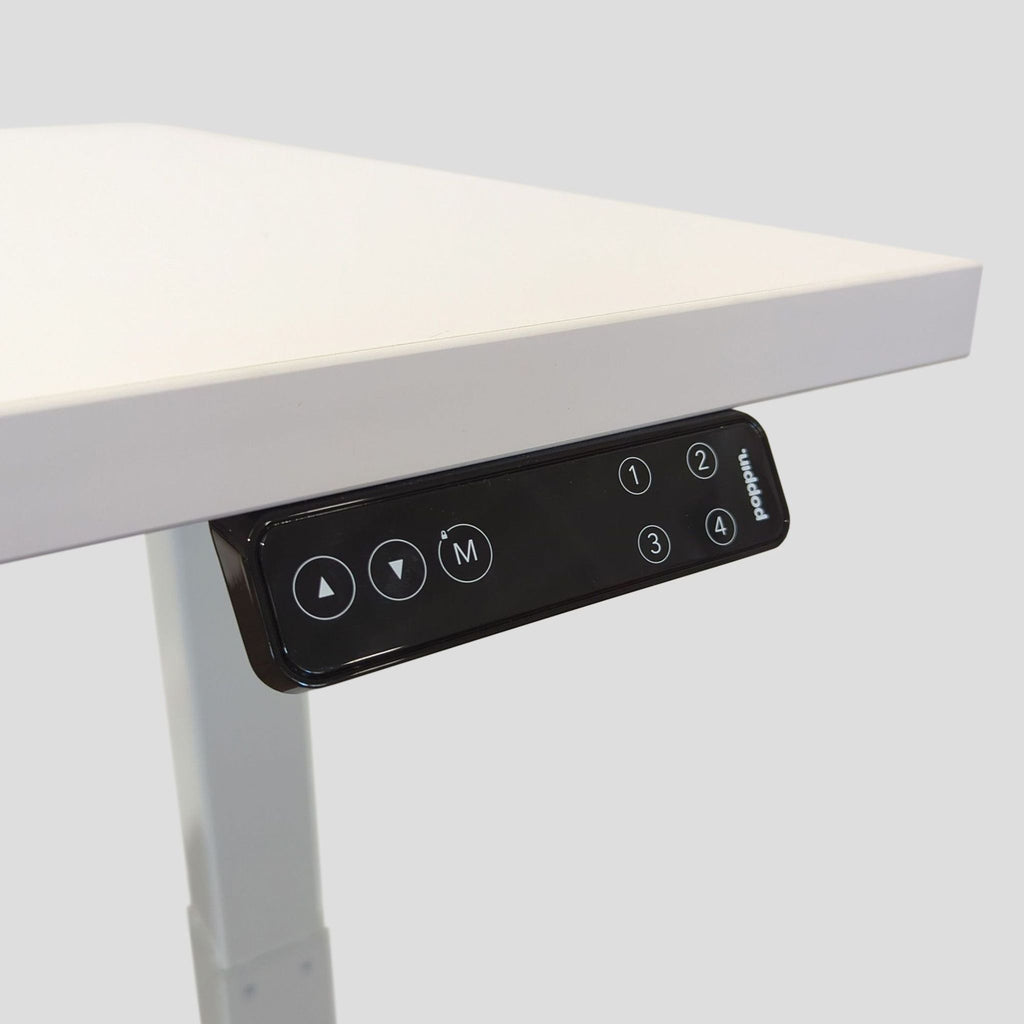 Sleek white Poppin desk with electric lift, easily switches between sitting and standing for workspace flexibility.