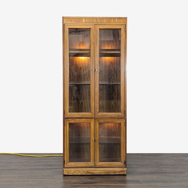 Wood cabinet with glass shelves, interior lights, and ample storage space, shown in the Cabinet category.  