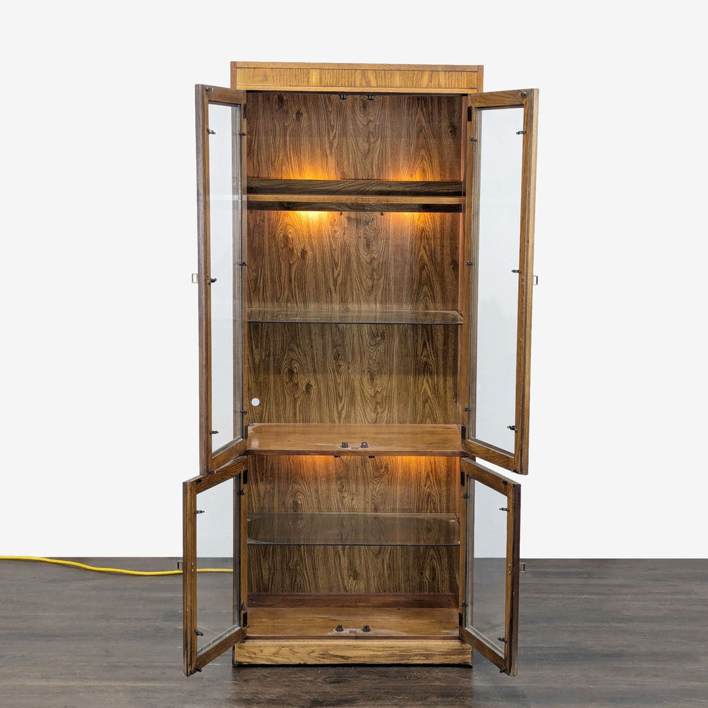 Modern wood cabinet illuminated inside, featuring glass shelving and generous storage capacity.  