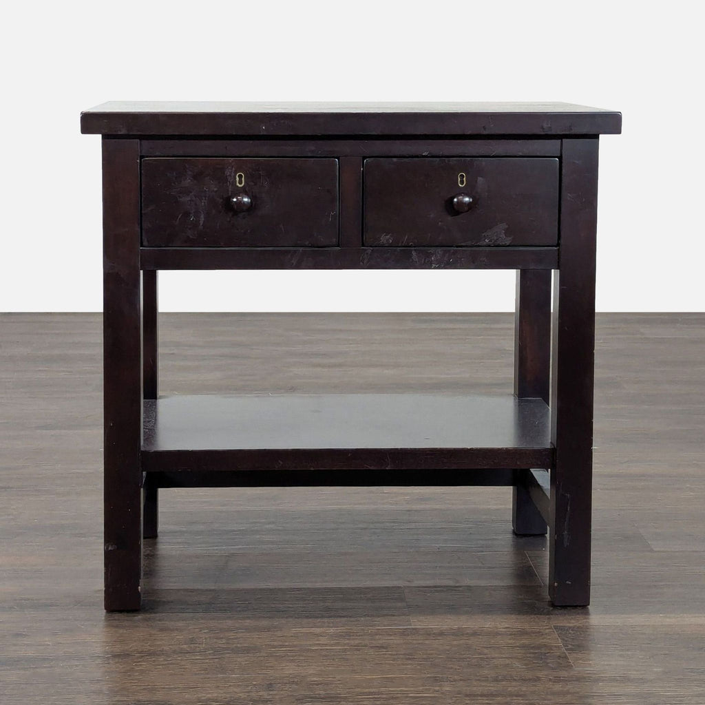 Pottery Barn end table with two drawers, lower shelf, and dark wood finish, perfect for bedside storage.
