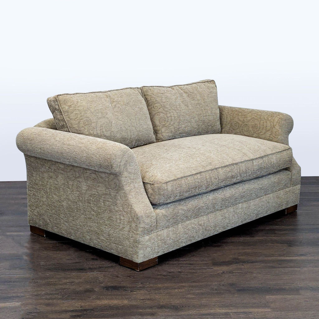Patterned-upholstery loveseat with soft back and wide seat, ideal for cozy living room seating.