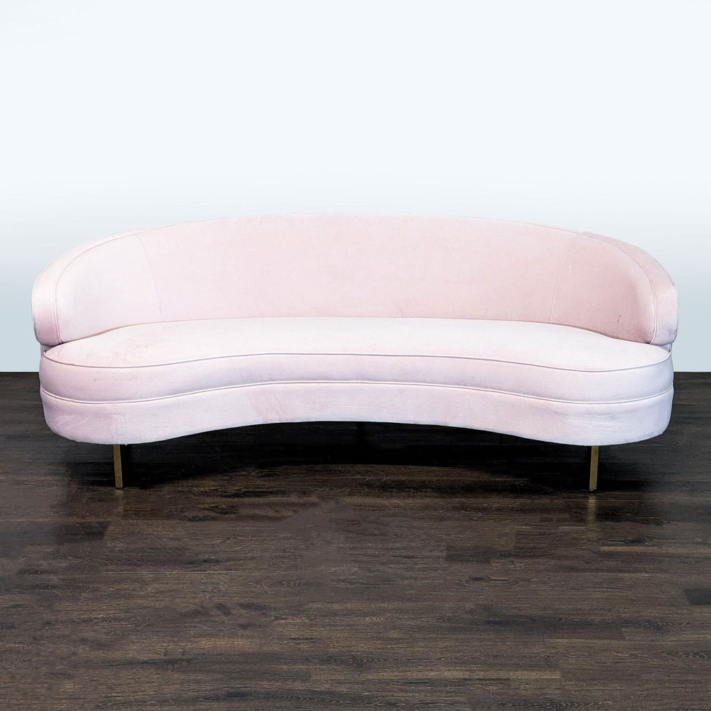 Safavieh pink velvet 3-seat sofa with curved design and gold legs, offering modern elegance and comfort.  