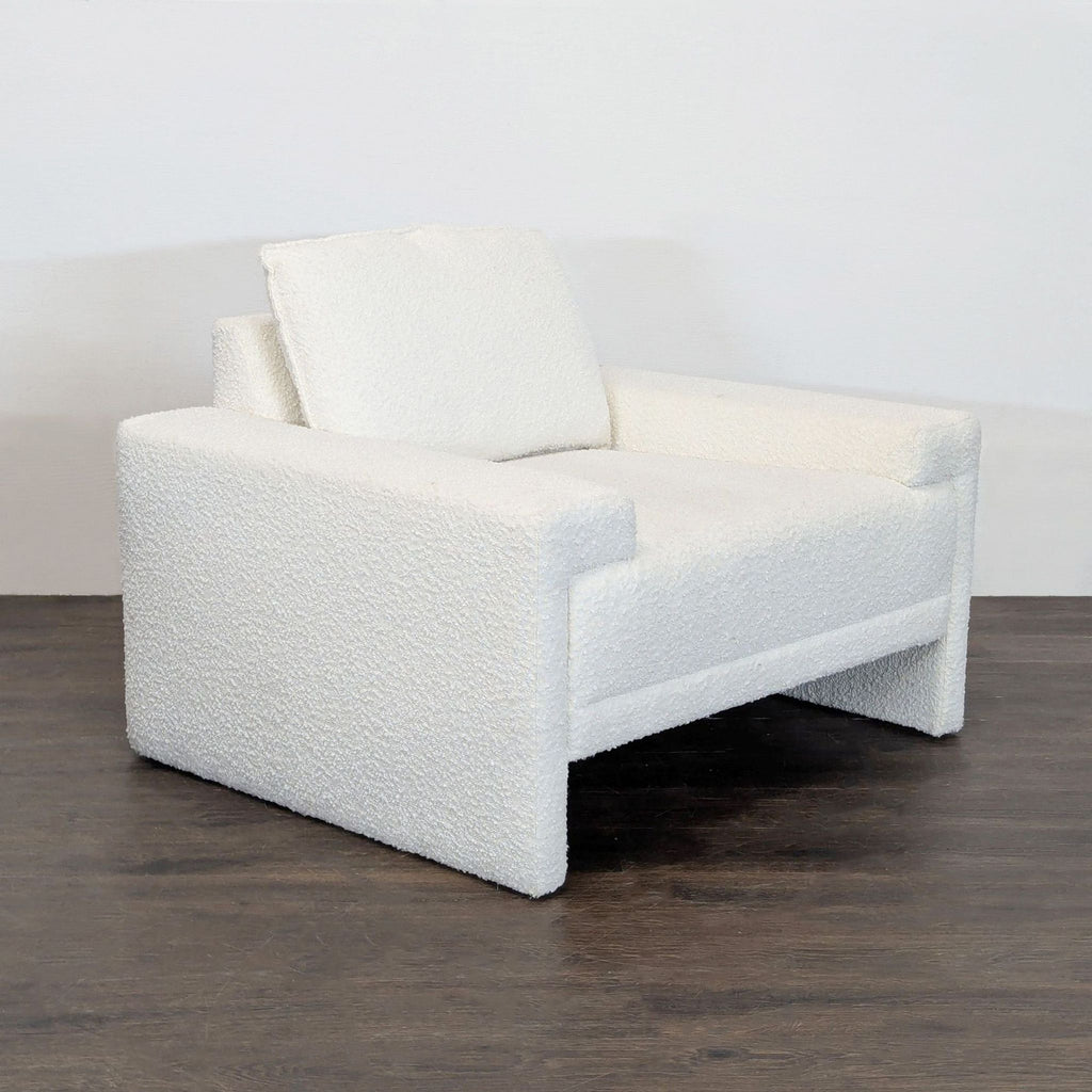 Chic TOV Furniture lounge chair in white bouclé, featuring a supportive backrest and wide, comfy arms.  