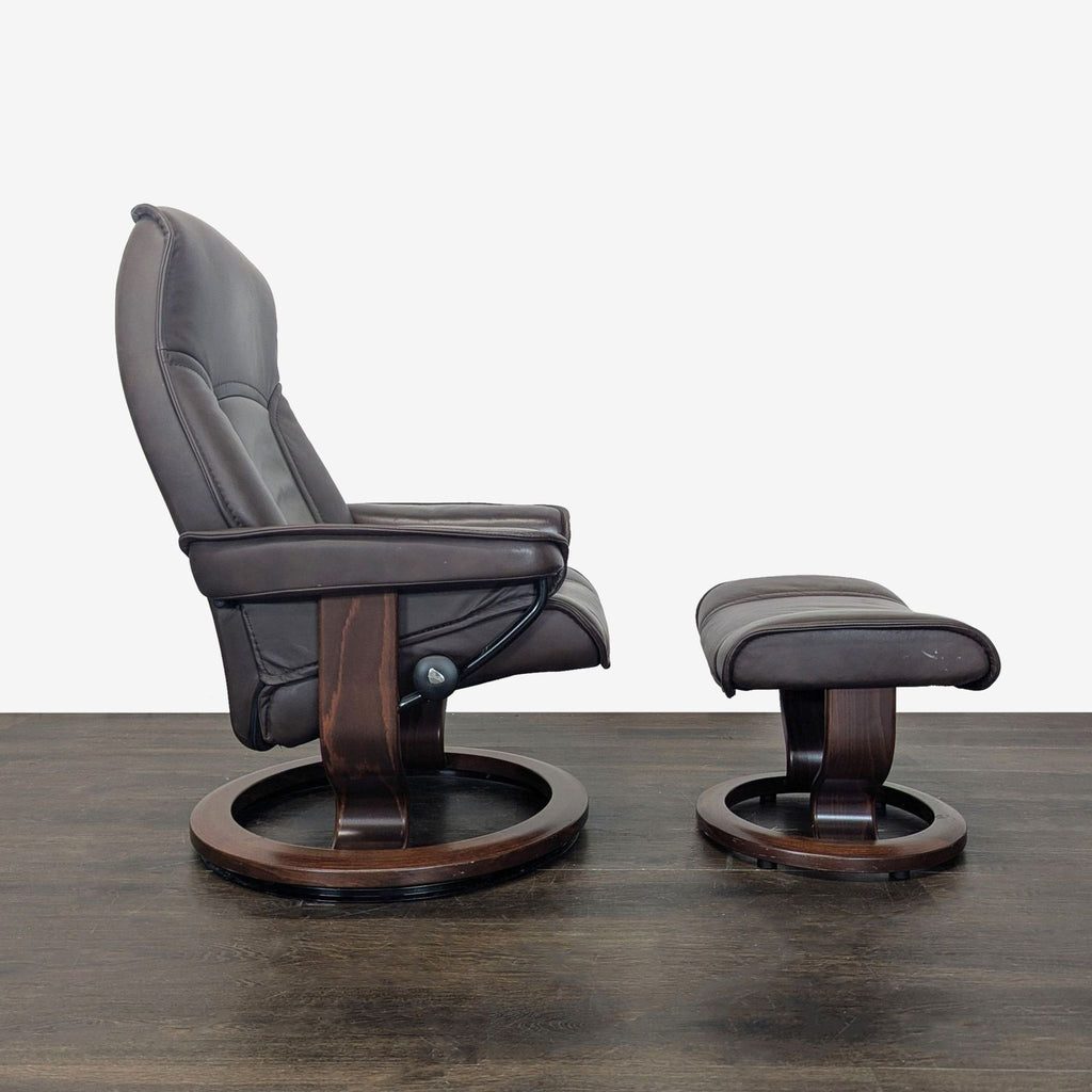 Sleek Stressless chair and matching ottoman in rich leather, featuring swivel function and sturdy wooden base.