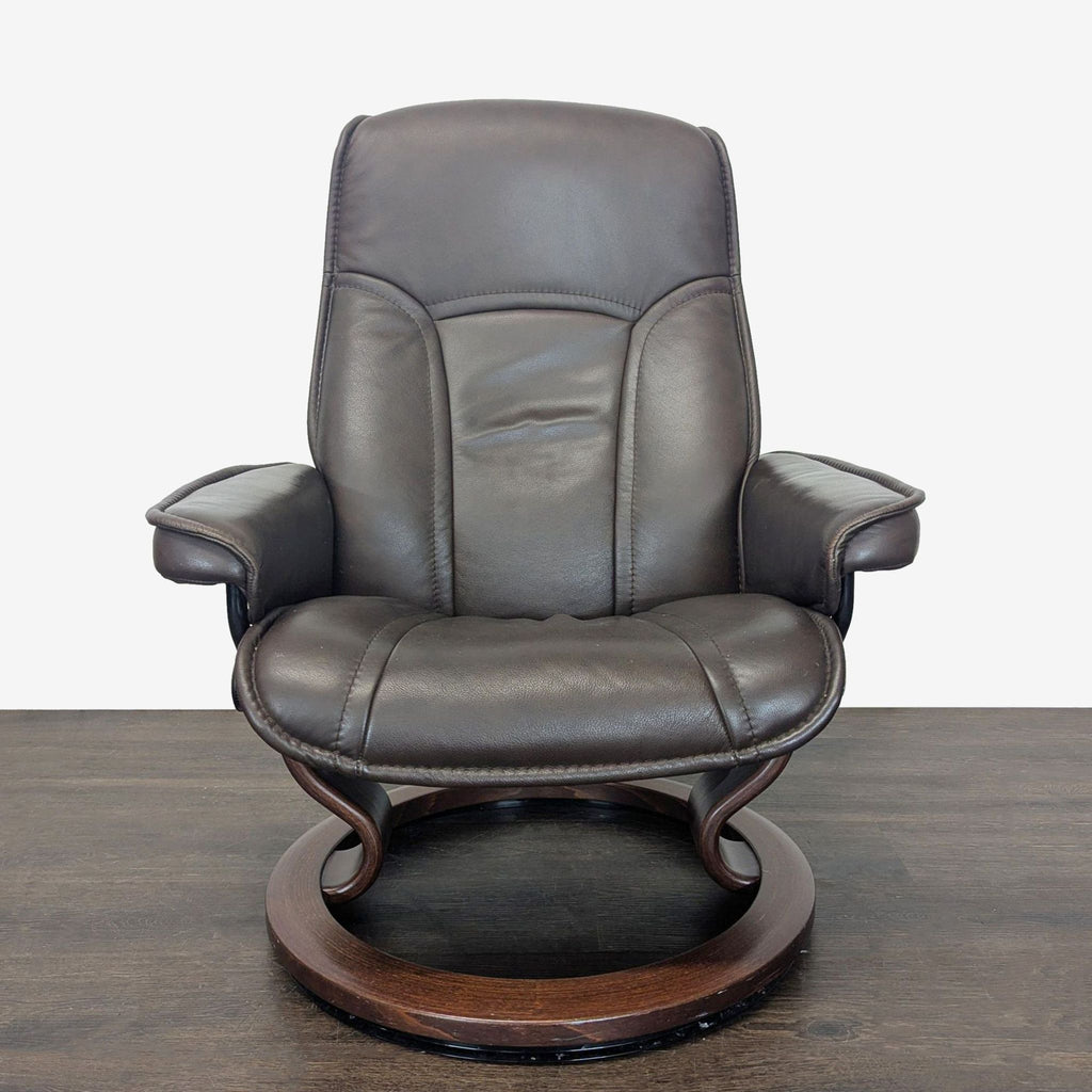 Elegant Stressless lounge chair with ottoman; supportive design, dark leather upholstery, and designer wood frame.