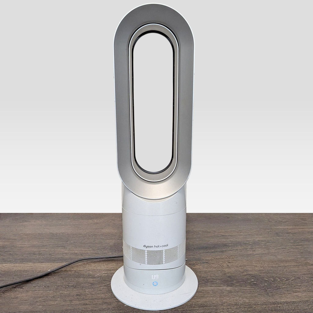 2. Modern Dyson air conditioner and fan, upright and bladeless, displayed under good lighting.  