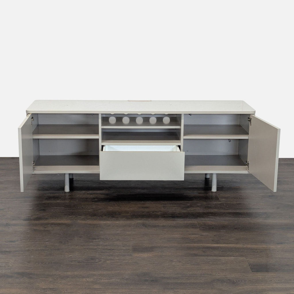 Neutral-finish Ikea media console featuring side cabinets, a central open shelf, and a roomy bottom drawer.