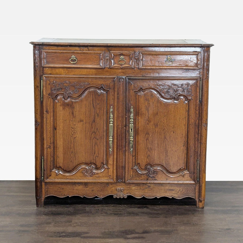 Elegant carved wood sideboard with metal hardware, three drawers, and two doors opening to spacious shelves.