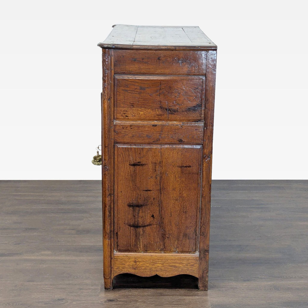 Traditional sideboard with intricate carved accents, upper drawers, dual doors with metal knobs, and interior shelving.