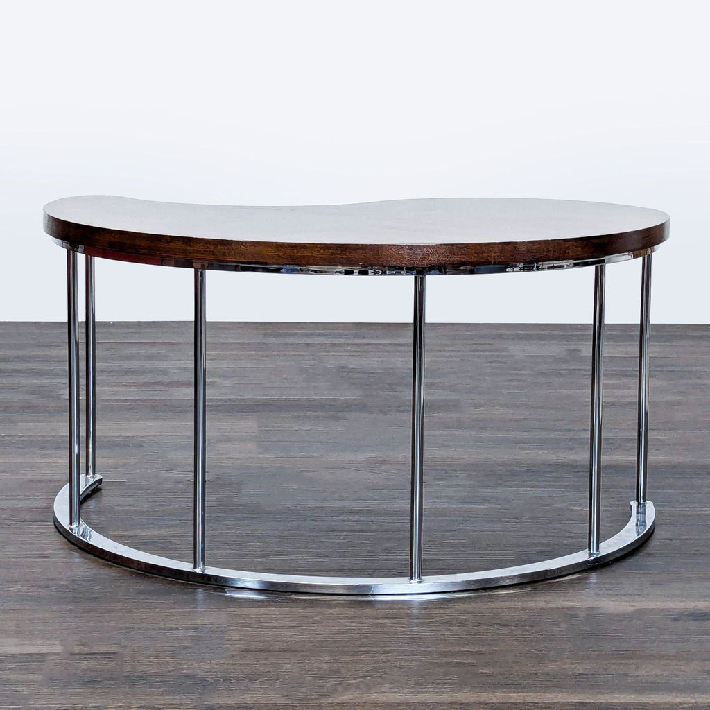 Chevron wood pattern coffee table with chrome base, viewed from above.