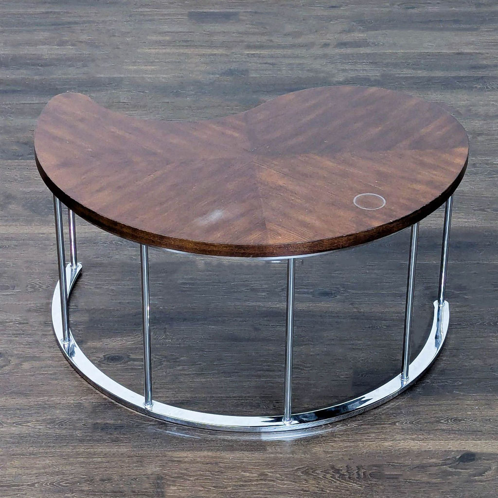 Modern coffee table featuring chevron wood top and shiny chrome legs.