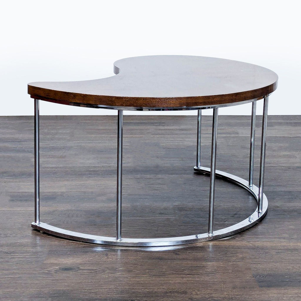 Coffee table with chevron-patterned wood surface and a chrome-finished base.