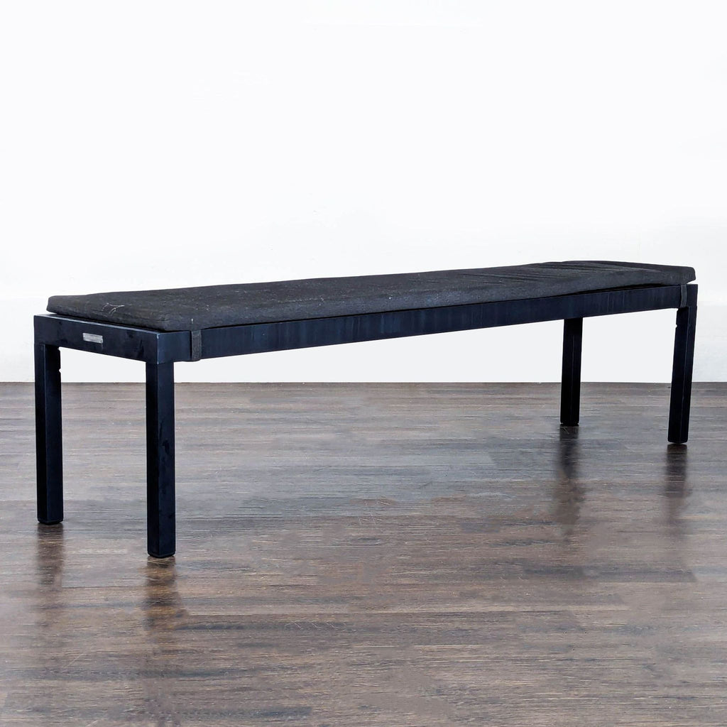 1. Modern upholstered ottoman with wooden legs from Crate & Barrel, ideal for living rooms.  