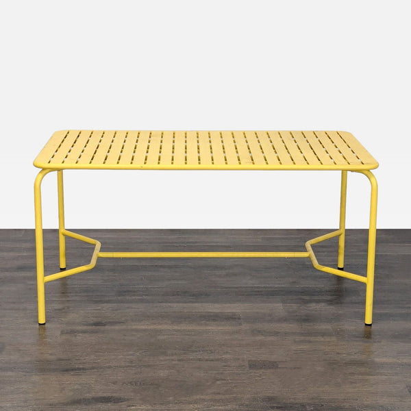 Bright yellow Petite Friture table with a metal slatted top and modern rectangular design for versatile use.  