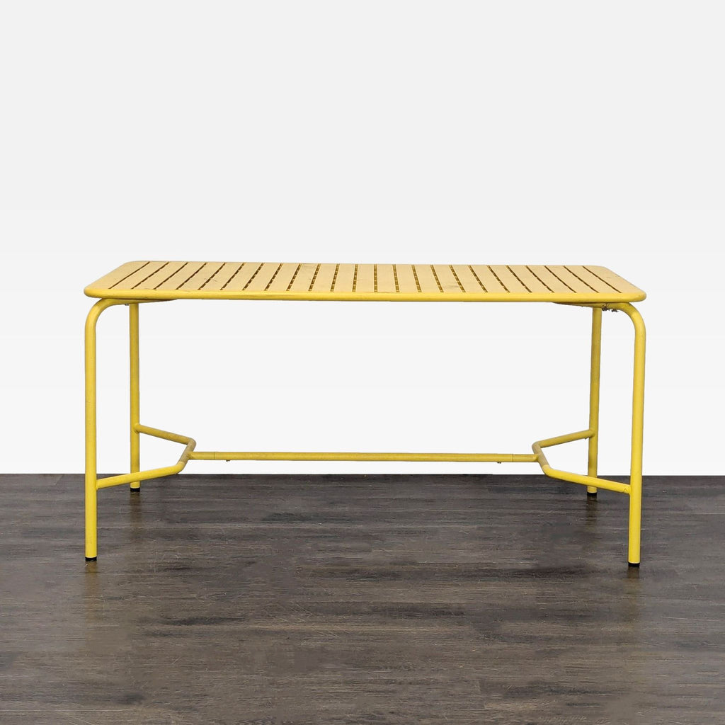 Rectangular coral-colored outdoor dining table with slatted top by Petite Friture, seats 6-8 people.