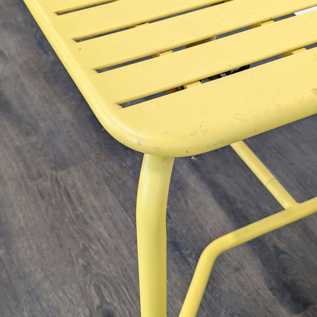Modern coral Petite Friture table for outdoor dining, features a slim slatted design and rounded edges.