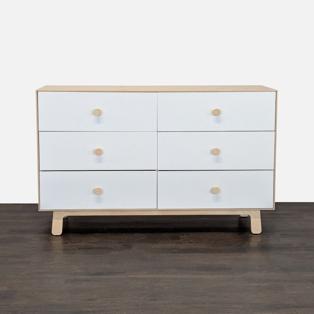 Modern Oeuf dresser with natural birch frame and six white drawers, offering spacious, stylish bedroom storage.  