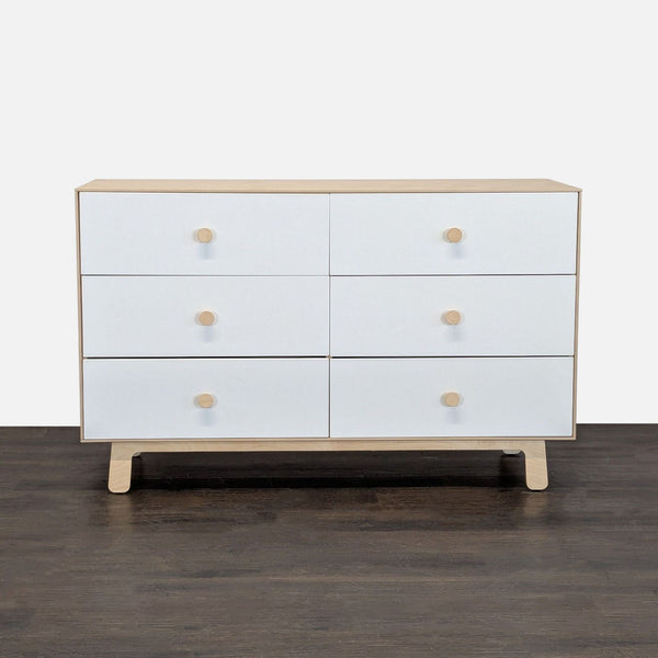 Modern Oeuf dresser with natural birch frame and six white drawers, offering spacious, stylish bedroom storage.  