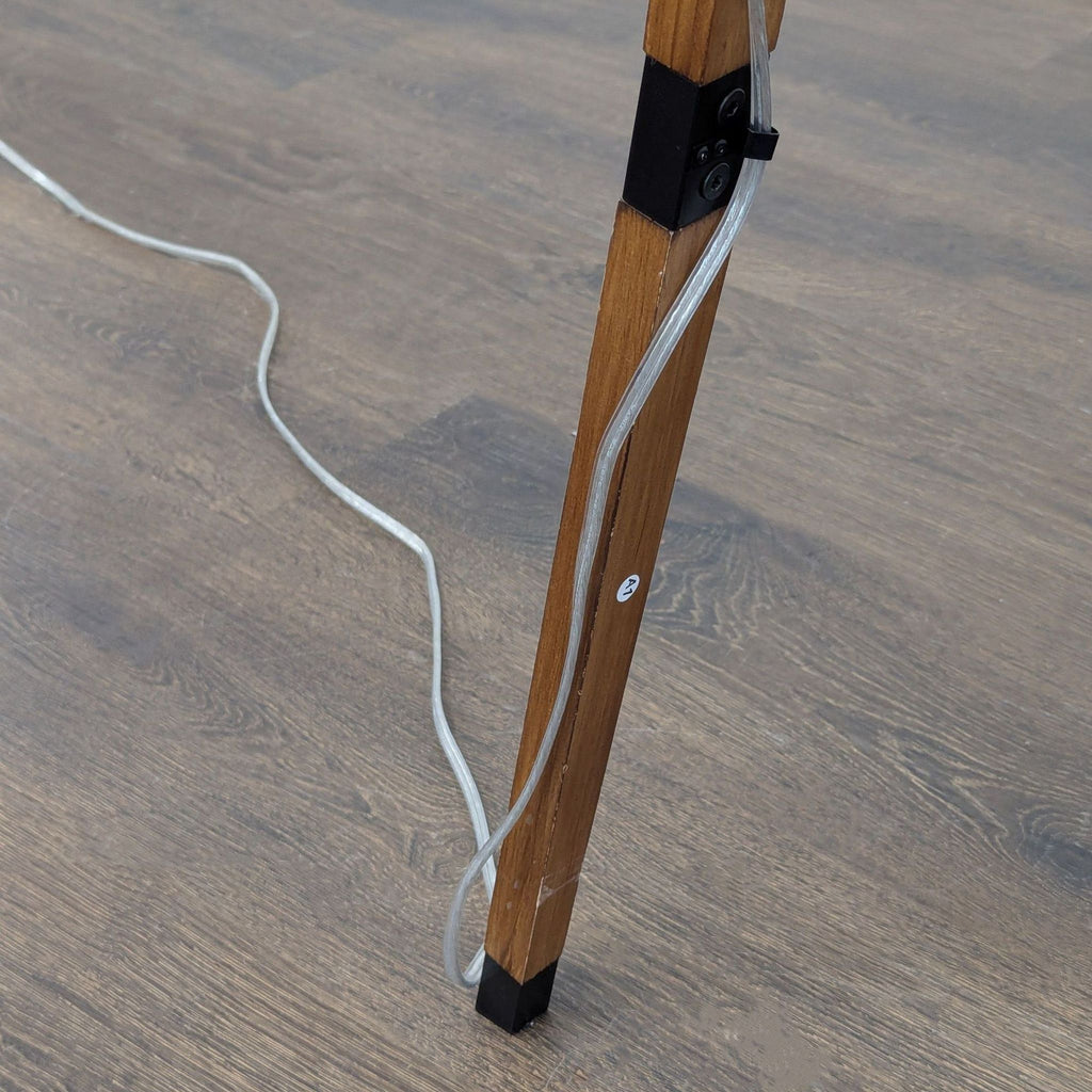 Stylish lighting: Target lamp with wood legs, white drum shade, and small shelf for decor or storage.