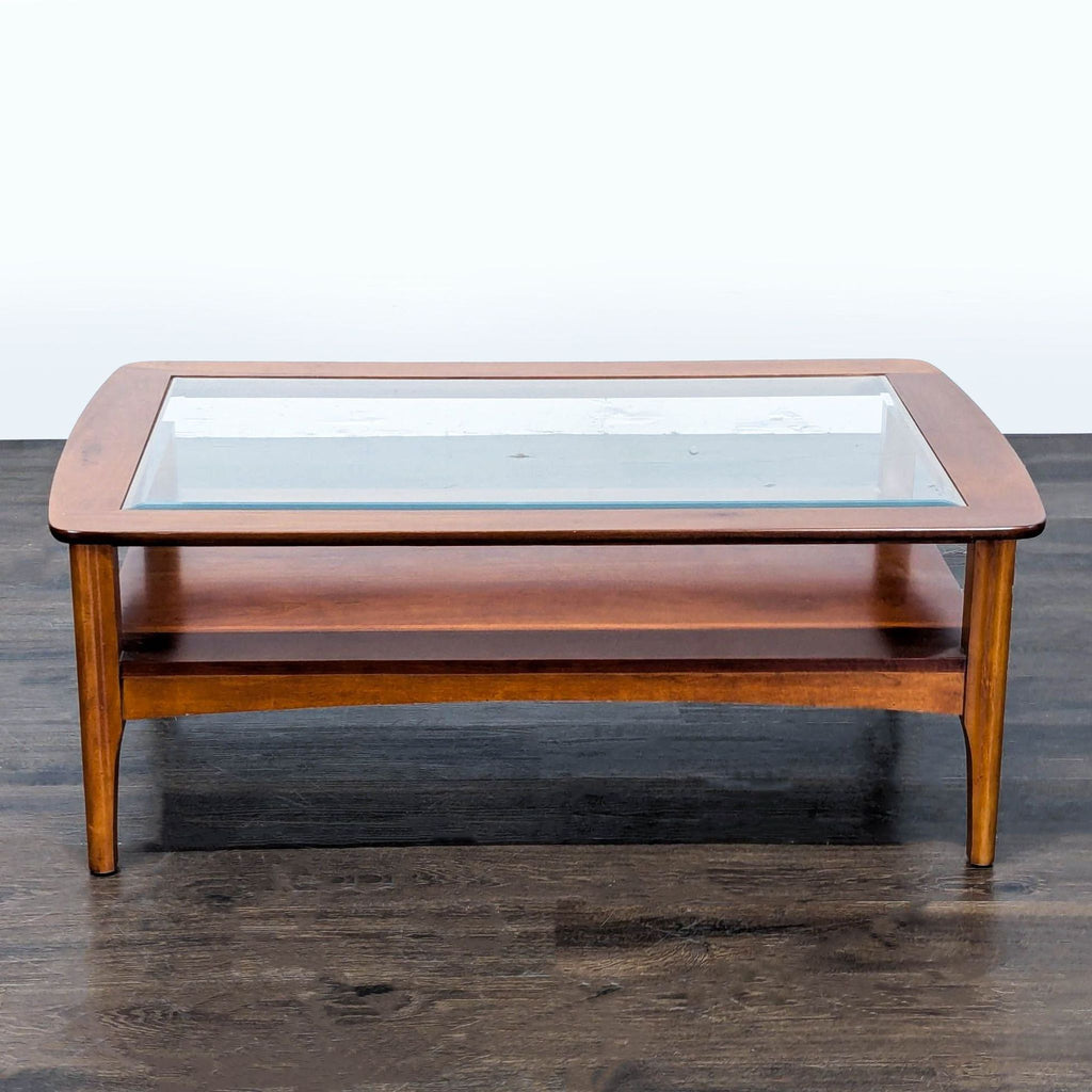 Modern coffee table featuring a clear beveled glass top and lower glass shelf by Riverside Furniture.  