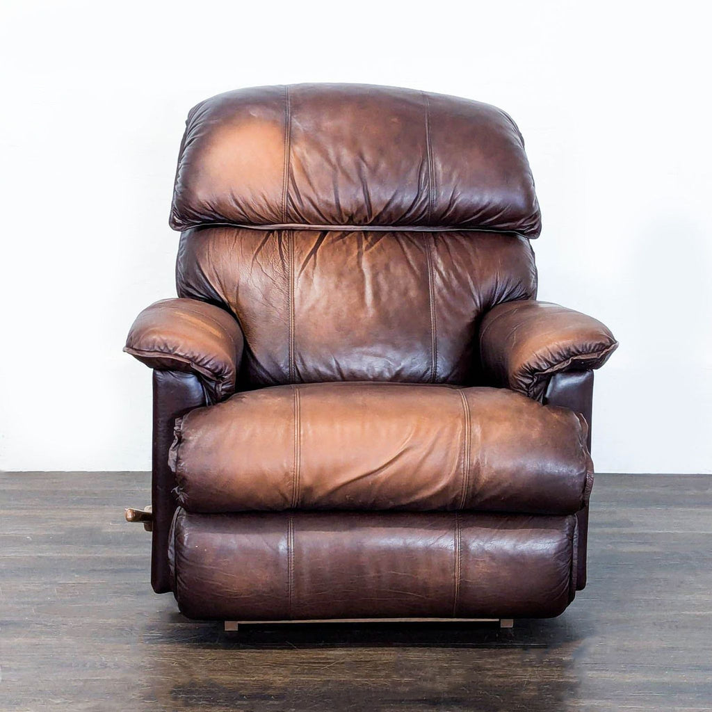 1. Front view of a La-Z-Boy lounge recliner in brown leather with plush cushions and padded armrests.