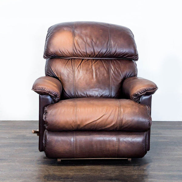 1. Front view of a La-Z-Boy lounge recliner in brown leather with plush cushions and padded armrests.