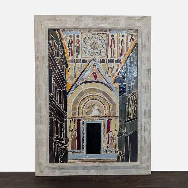 Handmade mosaic of a cathedral entrance with colored glass tiles in a rustic wooden frame.