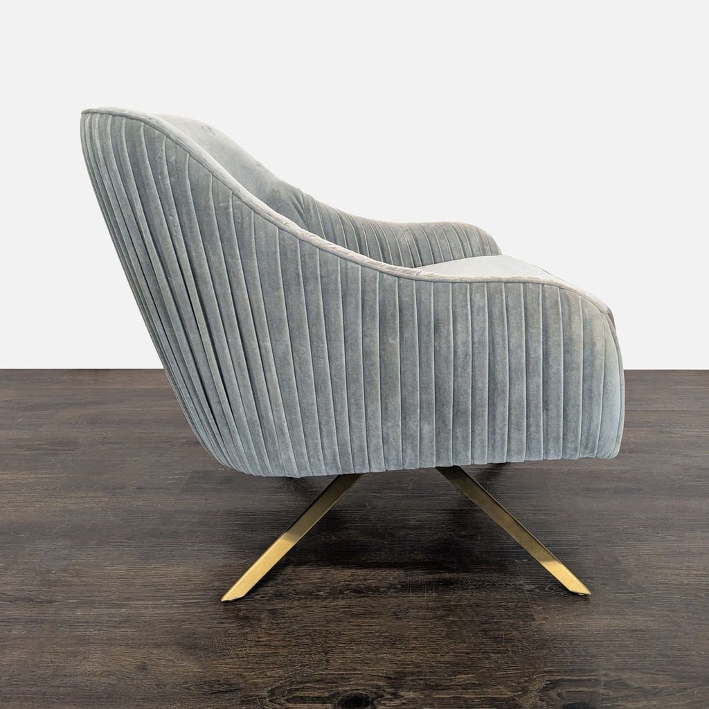 Modern West Elm lounge chair featuring soft gray velvet, ribbed sides, and a sleek gold base.