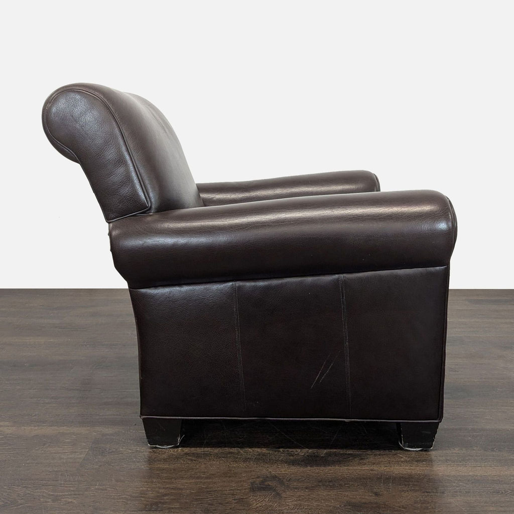 Classic lounge chair in dark brown leather featuring padded comfort, rolled arms, and sturdy construction.