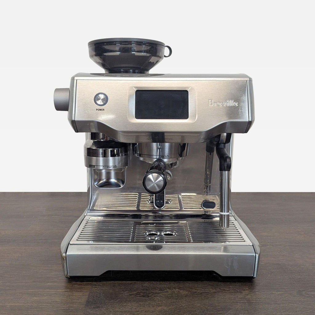 Breville stainless steel coffee maker with integrated grinder, steam wand, jug, and knock box, in excellent condition.  