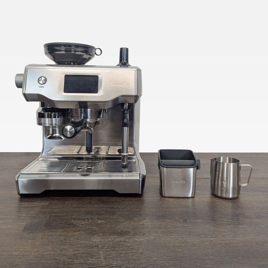 Breville espresso machine features a built-in grinder, milk frothing jug, and knock box, ideal for home baristas.  