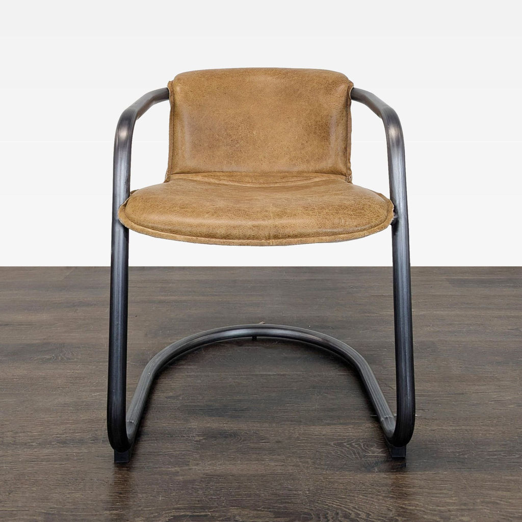 Brown leather lounge chair with a black metal curved frame, blending comfort with modern, industrial style.