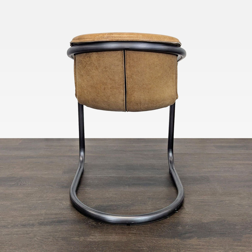 Modern brown leather lounge chair with a steel frame, designed for both comfort and chic, industrial flair.
