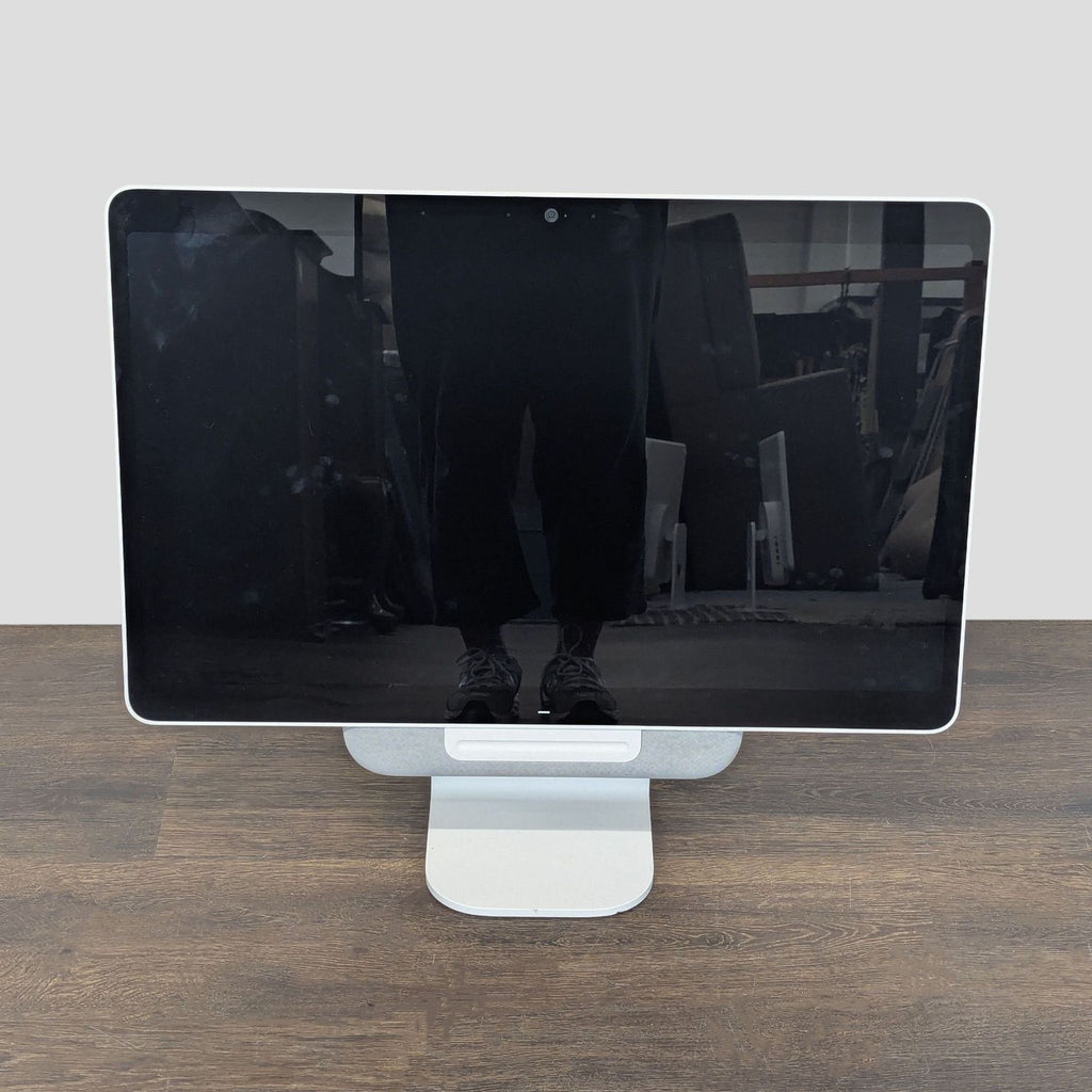 Avocor touchscreen monitor with built-in camera, stand, and power adapter for video conferencing or presentations.