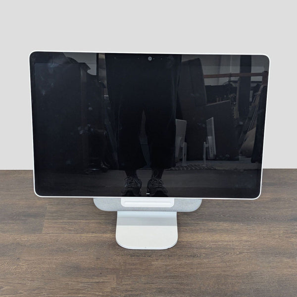 Avocor touchscreen monitor with built-in camera, stand, and power adapter for video conferencing or presentations.