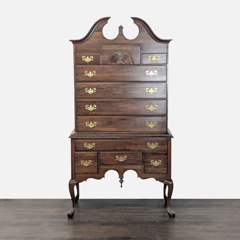 Pennsylvania House highboy dresser with brass hardware, shell motif, and seven drawers on cabriole legs.