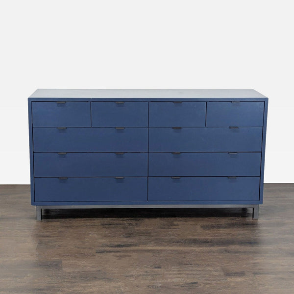 Modern navy Room & Board dresser with 10 drawers, offering stylish storage for clothes and accessories.