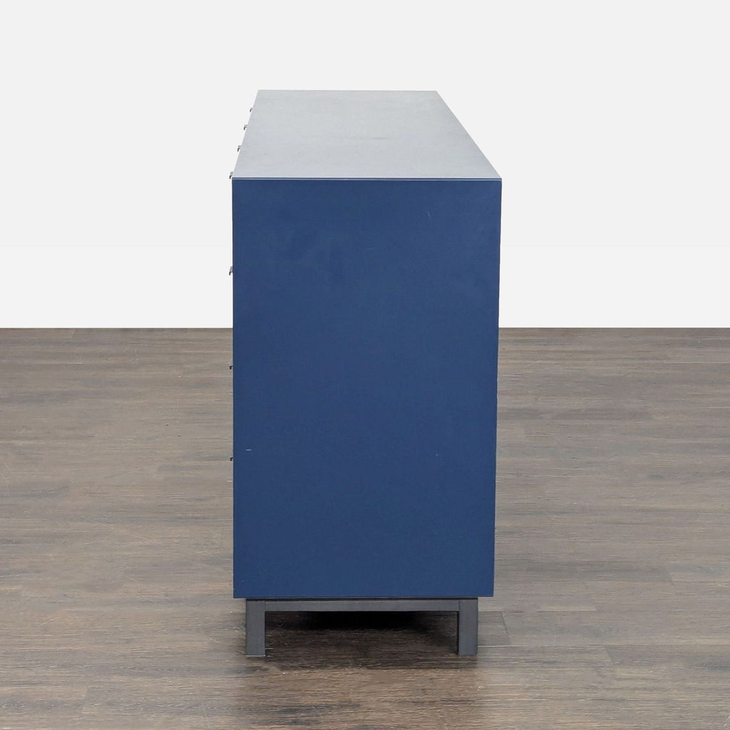 Ten-drawer Room & Board dresser in navy, ideal for bedrooms, combining ample storage with modern appeal.