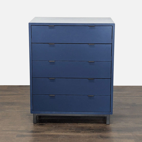 Modern blue Room & Board dresser with five drawers, sleek lines, and easy-pull handles for bedroom storage.