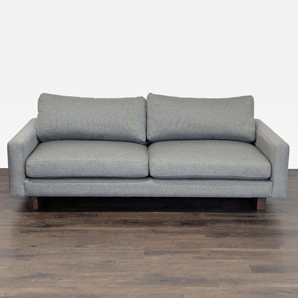 Gray Room & Board loveseat with plush cushions and wooden legs, ideal for modern living rooms or offices.